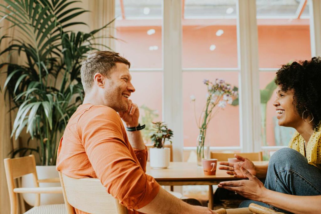 Couple Talking In Cafe 