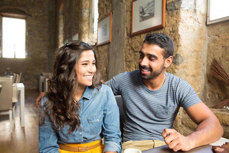 Couple Talking In Cafe 