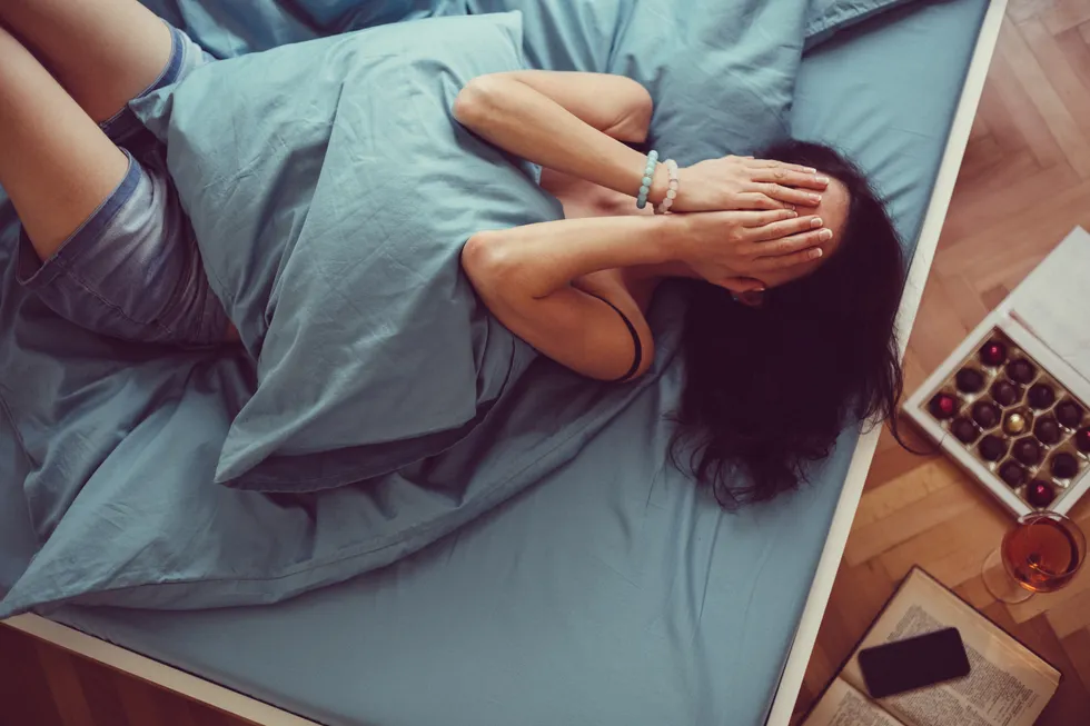 Depressed Young Woman In Bed 