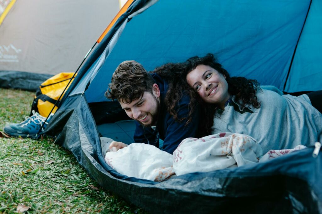 Happy couple relaxing in camping tent 